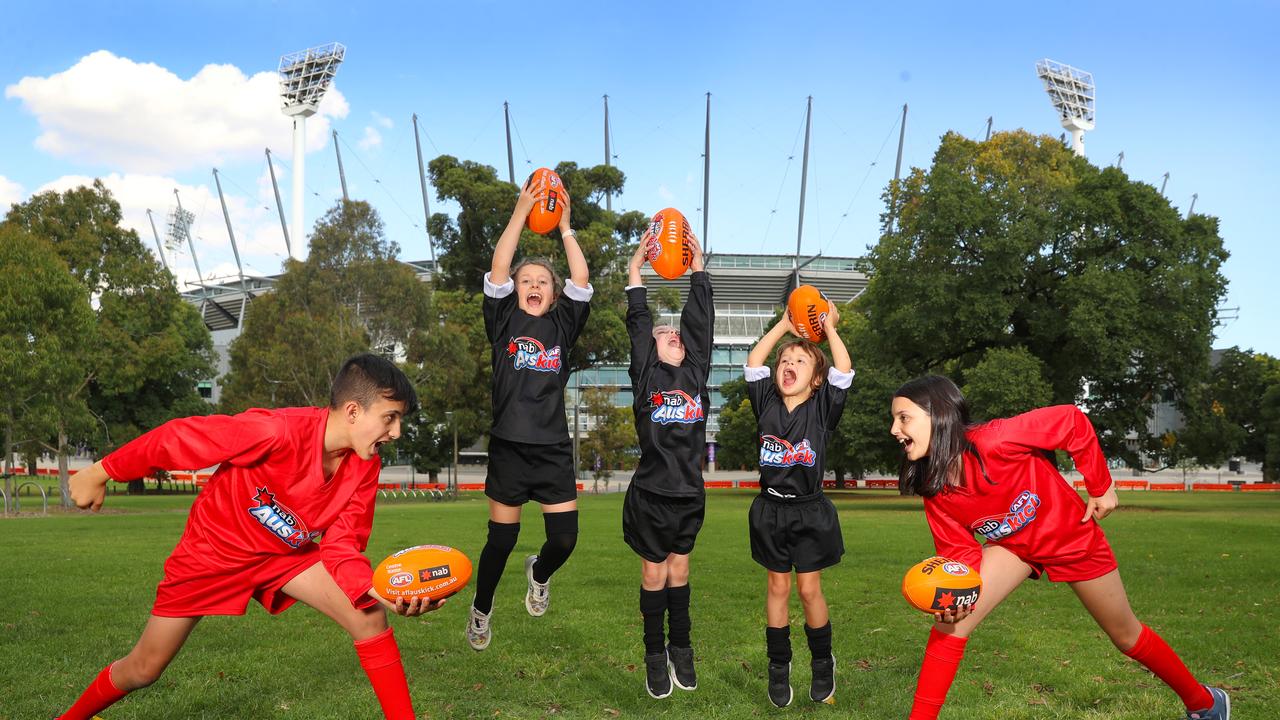 Jasper, 12, Elsie-May, 7, Jack, 5, Perry, 5, and Allegra, 10, warm up for the return of Auskick at halftime as part of the resumption of AFL at the MCG. Picture: Alex Coppel.