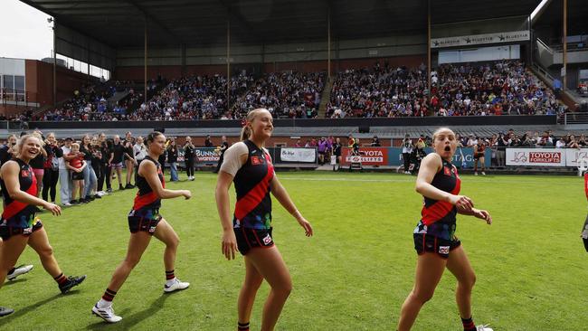 Essendon’s AFLW squad walks off the Windy Hill oval before a record crowd on Sunday. Pic: Michael Klein