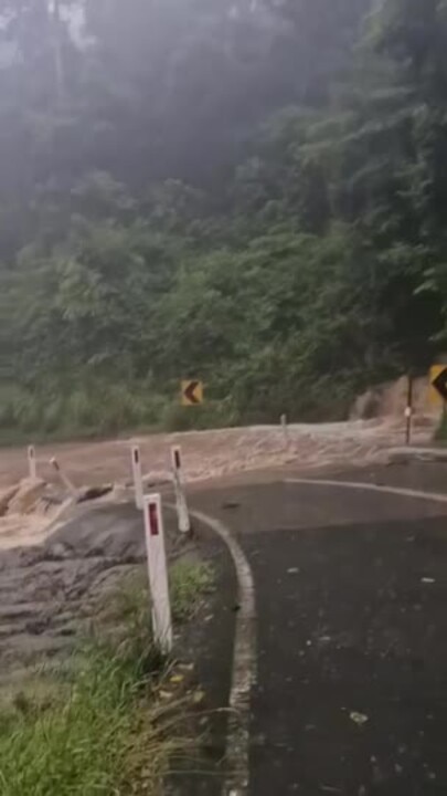 Water flooding a road at Eungella range