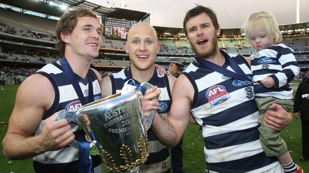 Cameron Mooney (right) holds the 2009 premiership cup with Joel Selwood and Gary Ablett.