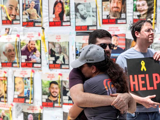 A man and woman embrace during a protest by the families of the hostages and their supporters outside the Defence Ministry headquarters in Tel Aviv. Picture: AFP