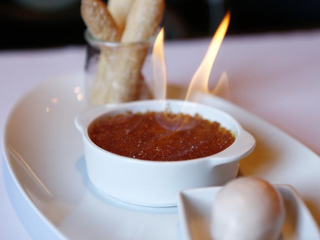 Like a Parisian showgirl, the flaming creme brulee adds drama, arriving at the table with a flame tail which proves a major head turner. Picture: Tim Hunter