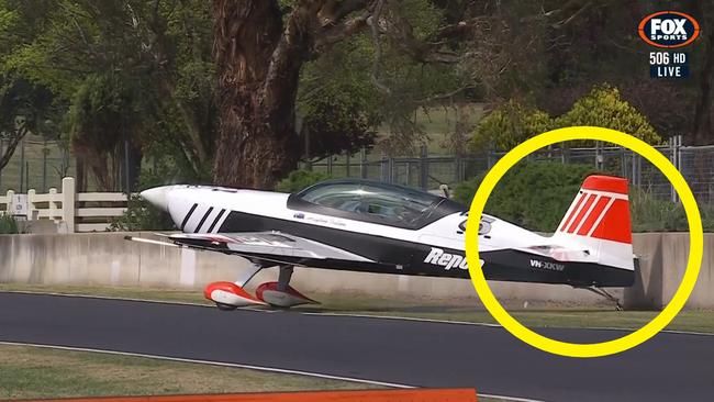 Debris from the plane went flying after hitting the wall. Photo: Fox Sports.