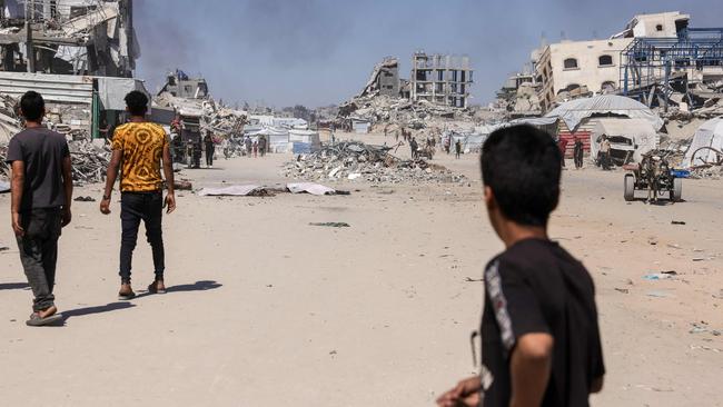 A Palestinian boy looks on as smoke billows following an Israeli drone strike in Jabalia, northern Gaza.