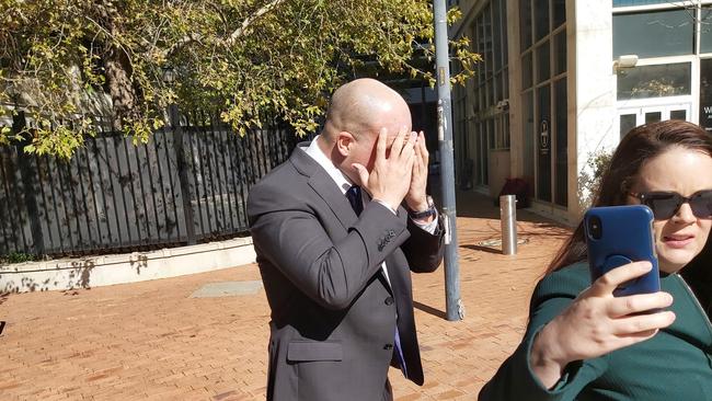 Australian diplomat Neal Kretschmann, 36, of Yarralumla in the ACT (centre), “appeared to be masturbating” in bushes outside a woman’s house. He is pictured leaving court with his partner (right). Picture: Craig Dunlop