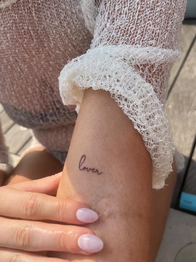 Logan Shine with the word ‘lover’ tattooed on her arm.