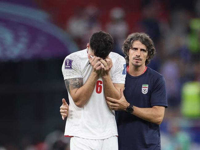 Iran's midfielder #06 Saeid Ezatolahi is comforted as he cries at the end of the Qatar 2022 World Cup Group B football match between Iran and USA. Picture: Fadel Senna/AFP