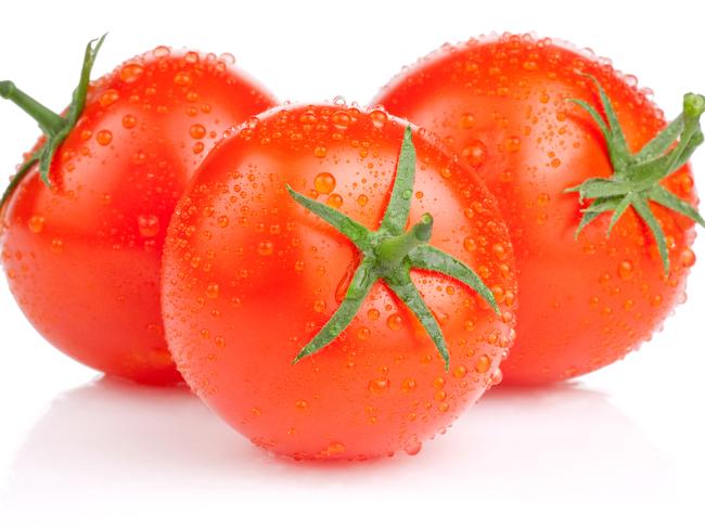 Three fresh juicy tomatoes with water droplets.