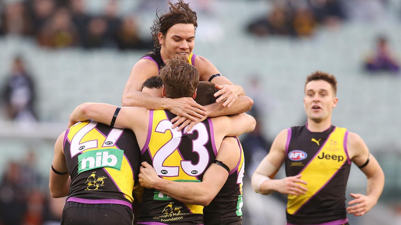 Richmond players mob Shane Edwards after he kicked a long third-quarter goal. Pic: Michael Klein