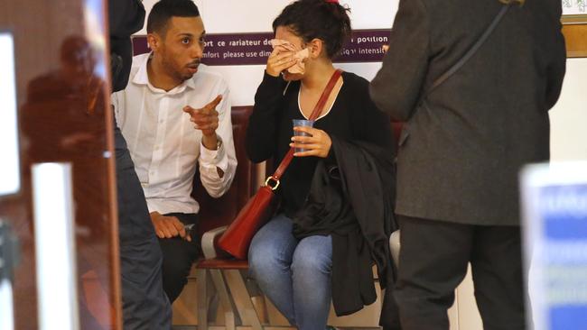 A relative of the victims of the EgyptAir flight 804 wipes her tears as she is comforted at Charles de Gaulle Airport outside of Paris. Picture: Photo/Michel Euler.