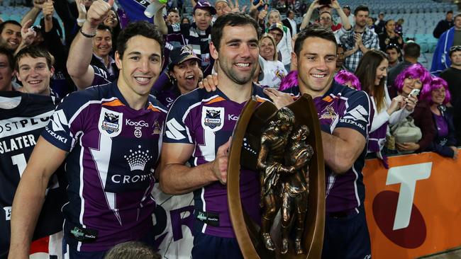 Billy Slater, Cameron Smith and Cooper Cronk celebrate Melbourne’s 2012 NRL premiership.