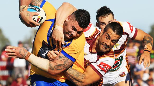 Andrew Fifita of City tackled by Paul Vaughan during last year’s match.