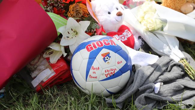 Mourners left a soccer ball and other tokens to pay tribute to Nicholas Hoenselaars. Picture: Tim Hunter