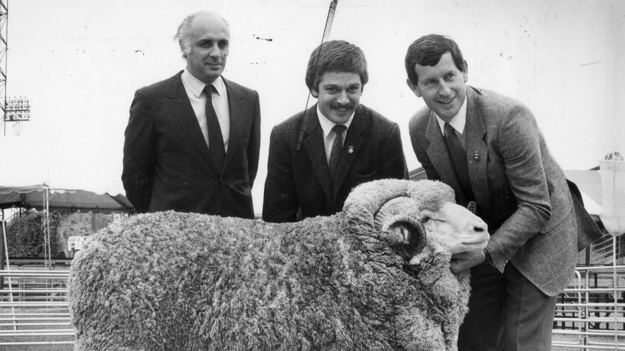 Royal Adelaide Show 1986 ram sales sets a world record price of $102,000 with a Collinsville ram. From left Mr Luis Piquemal and Dr Hernan Baldassarre, representatives of the new owner, Argentinian company, Goyaike S.A., with Neil Garnett of Collinsville stud holding the sheep.