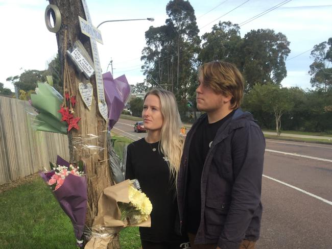 Jayden Mason's girlfriend Amber Newton and his brother James Mason pay their respects at a small memorial erected by the road. Picture: supplied.