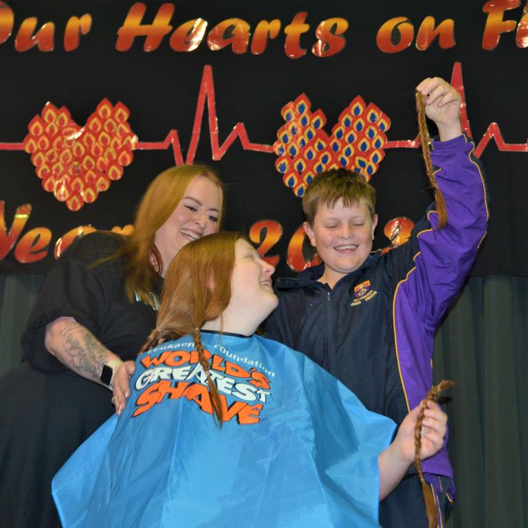 At the St Joseph's College 2023 World's Greatest Shave event is student Chelsee Kidd having her cut by her younger brother and hairdresser Rebecca Mortlock from the Hair Room on Russell. Picture: Rhylea Millar