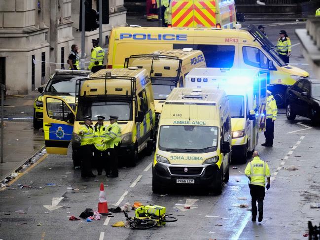Police and emergency personnel after the car collided with pedestrians. Picture: Danny Lawson/PA via AP