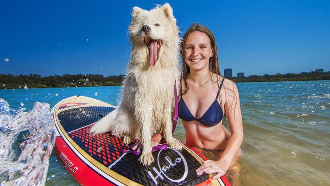 Wynter Saunders, 17, from Brisbane paddle boarding with her pooch Shelby at Currumbin Creek. Picture: NIGEL HALLETT.