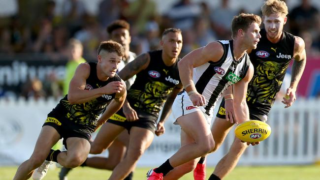 Taylor Adams readies to handball in the Magpies’ pre-season match against Richmond. Picture: Kelly Defina/Getty Images