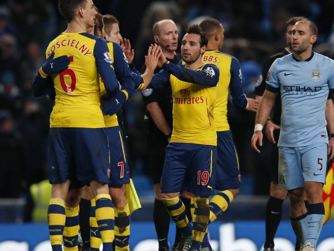 Arsenal's Santi Cazorla, second right No19, celebrates with his teammates at the end of the English Premier League soccer match between Manchester City and Arsenal at the Etihad Stadium, Manchester, England, Sunday, Jan. 18, 2015. Arsenal won the match 2-0, with Cazorla and his teammate Arsenal's Olivier Giroud scoring the goal.(AP Photo/Jon Super)