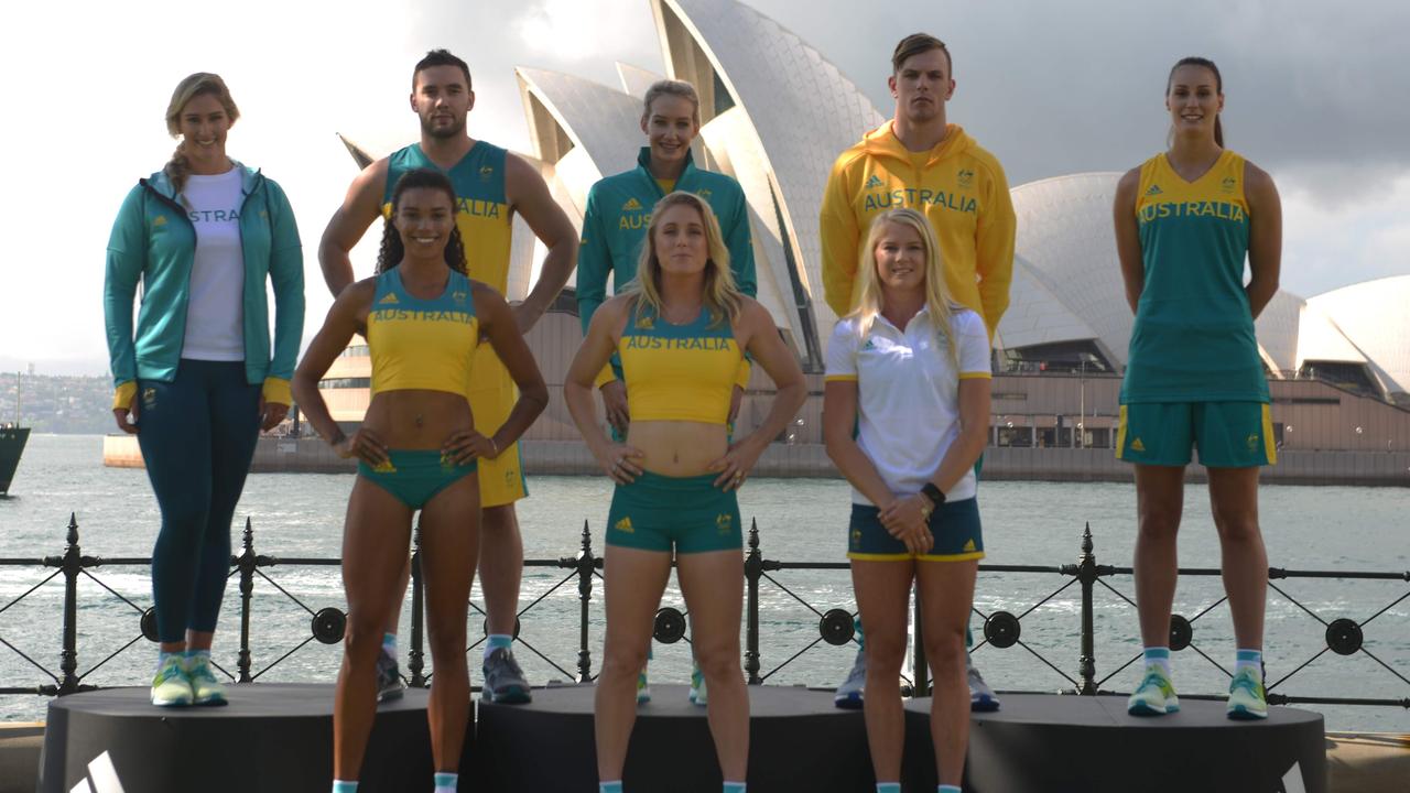 Australian Olympic athletes (L-R) Holly Lincoln-Smith – Water Polo, Morgan Mitchell – Athletics (400m), Adam Gibson – Mens Basketball, Madison Wilson – Swimming, Sally Pearson – Athletics (Hurdles), Brooke Stratton - Athletics (Long Jump), Kyle Chalmers – Swimming and Stephanie Talbot – Womens Basketball, pose for photos by Sydney Harbour at a media launch to unveil the official uniforms to be worn by the Australian Olympic team during the 2016 Games, on April 19, 2016. The Rio Olympics will be held from August 5-21, 2016. / AFP PHOTO / PETER PARKS