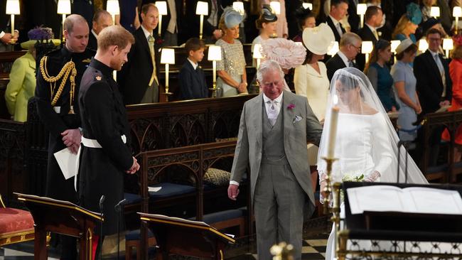 A ‘royal peculiar’ from the start … Prince Harry’s father Charles walks his soon-to-be daughter-in-law down the aisle in St George’s Chapel, Windsor, in 2018. Picture: AFP