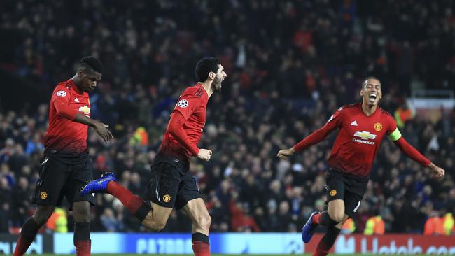 ManU midfielder Marouane Fellaini, center, celebrates after scoring