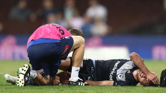 Melbourne Victory’s Terry Antonis receives treatment after going down with an injury against Sydney FC at the SCG. Picture: Getty Images