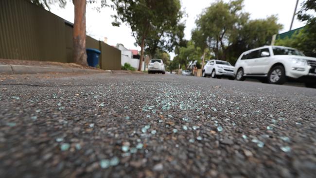 Glass scattered over the road from the smashed car window. Picture: Tait Schmaal