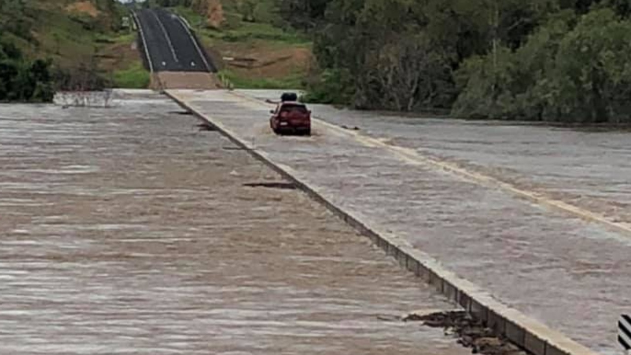 A motorist crosses the flooded Etheridge River Bridge into Georgetown at about 8.30am on Monday. PICTURE: AARON GALLAGHER