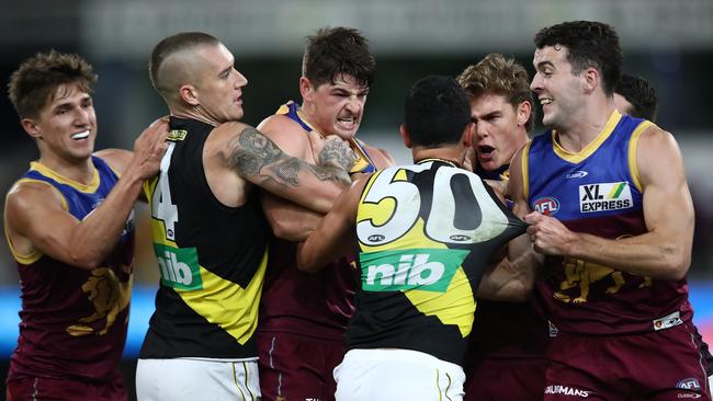 The Lions come for Tiger Marlion Pickett after his late hit on Brandon Starcevich. Picture: Jono Searle/AFL Photos