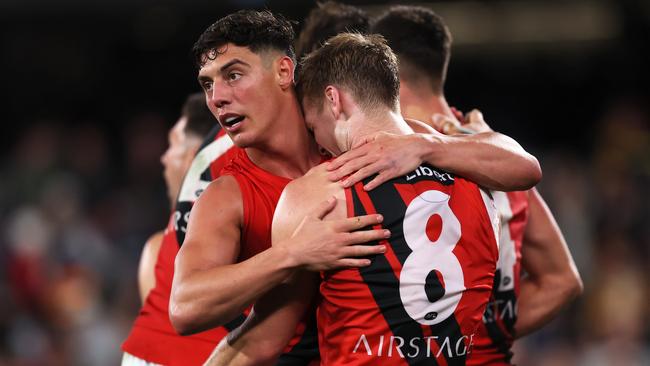 ADELAIDE, AUSTRALIA - APRIL 19: Jye Caldwell and Ben Hobbs of the Bombers celebrate their win during the 2024 AFL Round 06 match between the Adelaide Crows and the Essendon Bombers at Adelaide Oval on April 19, 2024 in Adelaide, Australia. (Photo by James Elsby/AFL Photos via Getty Images)