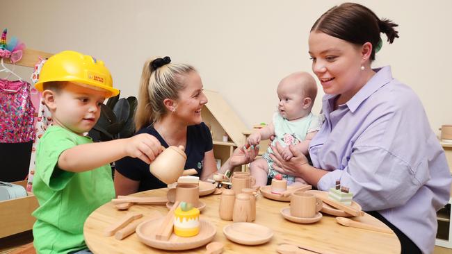 Four-year-old Hudson Lamb shows off his skills to Centre Director Kathryn Watson, sister Remi Lamb (five months) and mother Bella Lamb at Edge Early Learning Centre at Pimpama Village. Picture: Glenn Hampson.