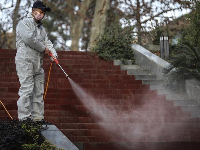 A man uses alcohol to disinfect the grounds nearby the Wuhan Huoshenshan hospital construction site in China. Picture: Getty Images