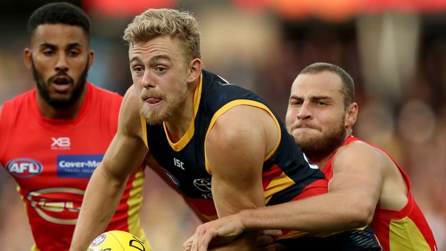 Hugh Greenwood gets a handball away in his first AFL game of the season on Sunday. Picture: James Elsby (Getty).