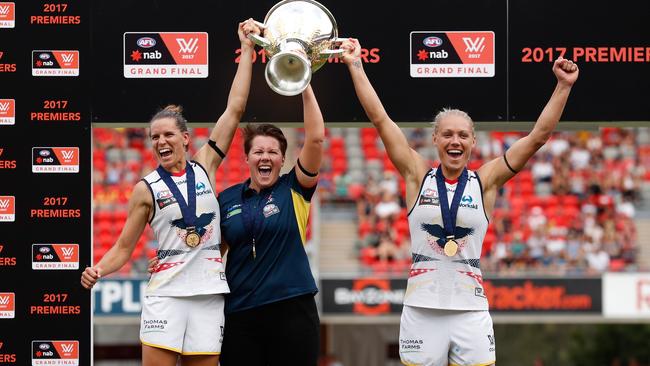 Chelsea Randall, Bec Goddard and Erin Phillips celebrate with the premiership cup. Picture: Getty Images