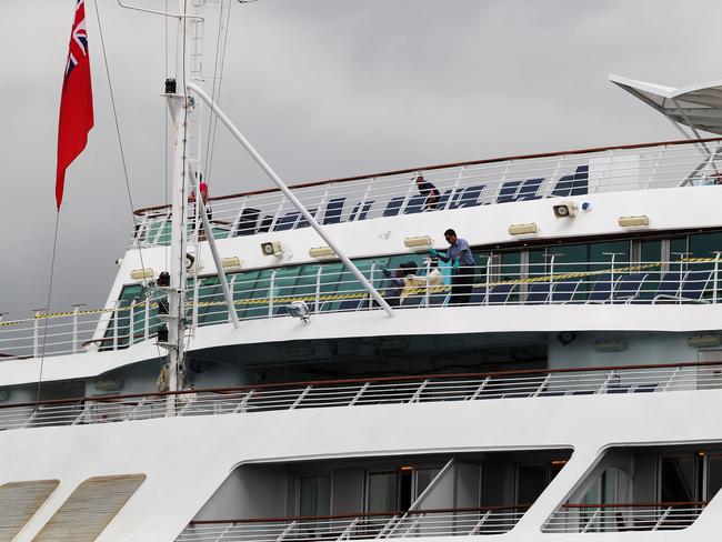 Cleaners clean the railings of the Sun Princess after it docked in Brisbane following an outbreak of norovirus in February 2017. Picture: Claudia Baxter