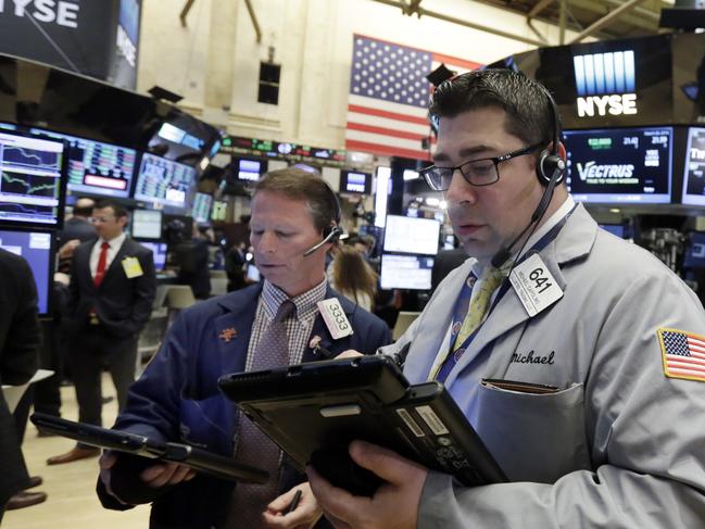Traders Robert Charmack, left, and Michael Capolino work on the floor of the New York Stock Exchange, Monday, March 28, 2016. Stocks are edging mostly higher in the early going. Markets are generally quiet with trading closed across Europe for the Easter holiday. (AP Photo/Richard Drew)