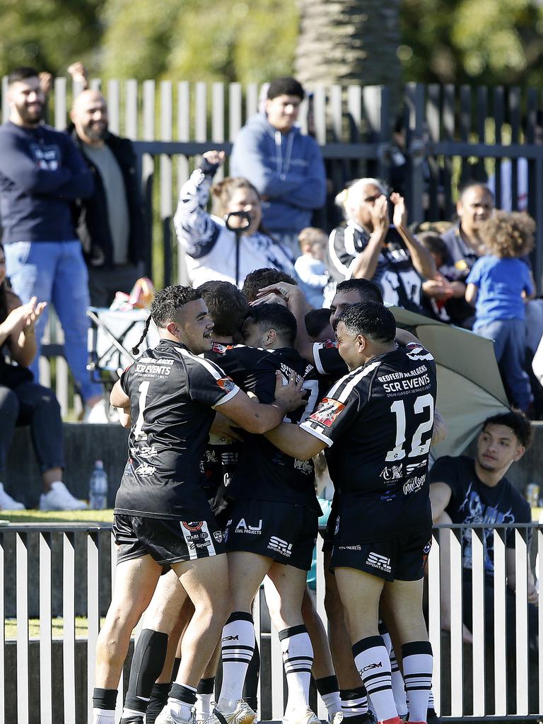 Redfern players celebrate a try. Picture: John Appleyard