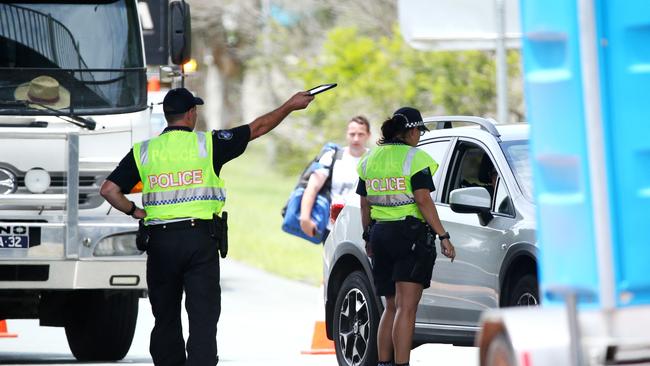 Police check drivers entering Queensland from NSW on the Gold Coast Highway. Picture: Nigel Hallett