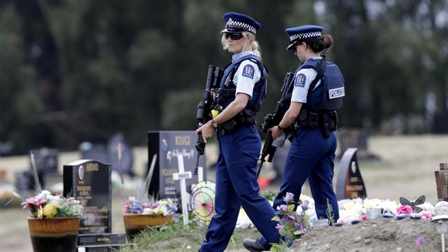 Armed police patrol a cemetery near Muslim graves in Christchurch, New Zealand. Picture: AP 