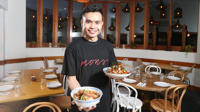 Mons Ban Sabai manager Nut Siri, holding two of the dishes which have propelled the Camp Hill restaurant into the top spot, according to our readers. Picture: AAP Image/Richard Gosling