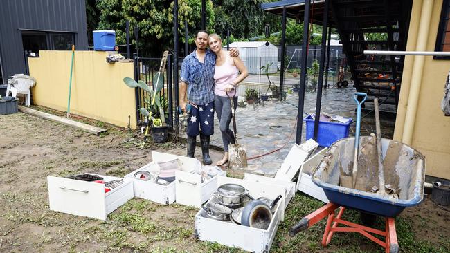 Caravonica residents Chris King and Krystal King comfort each other while cleaning up mess left by flood water that inundated their Lake Placid Road home on Sunday night. Picture: Brendan Radke