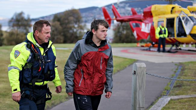 Stephen Ward, 13, walks from the Westpac Rescue helicopter on the Hobart Cenotaph this afternoon. Picture: RICHARD JUPE