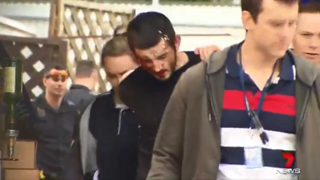 Television cameras caught the moment police took a bloodied suspect into custody. Picture: 7 News