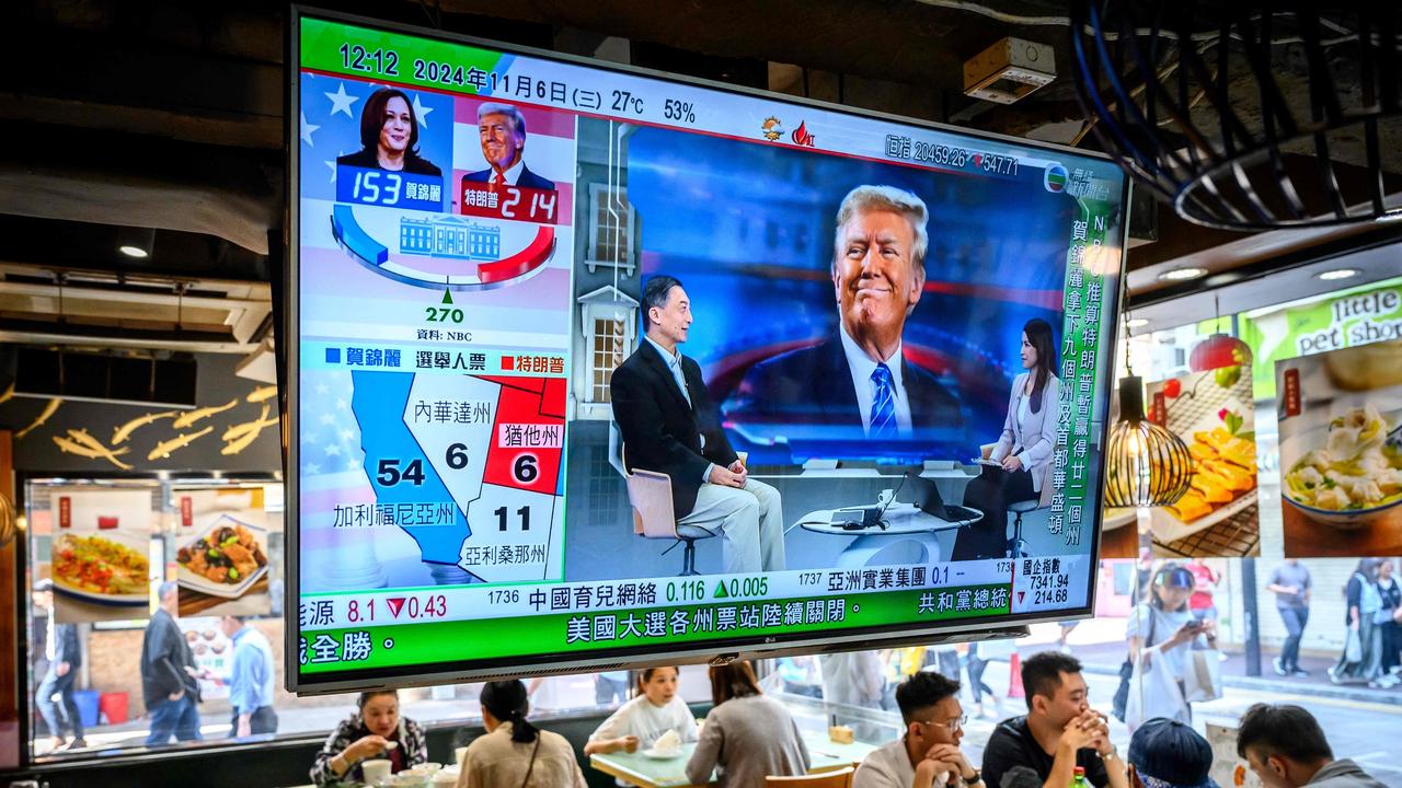 The whole world was watching the US election – this TV screen shows preliminary results in a restaurant in Hong Kong on November 6. Picture: Mladen Antonov/AFP