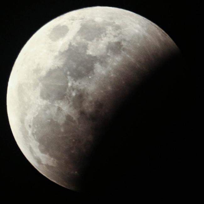 The super blood full moon seen over Darwin on Wednesday night. Pictures: Glenn Campbell