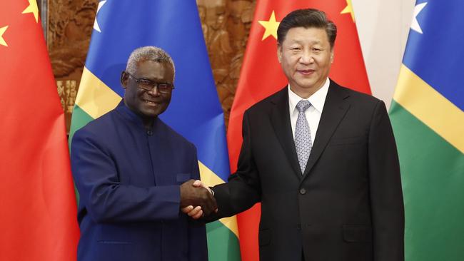 Manasseh Sogavare, left, with Chinese President Xi Jinping. Picture: Getty Images