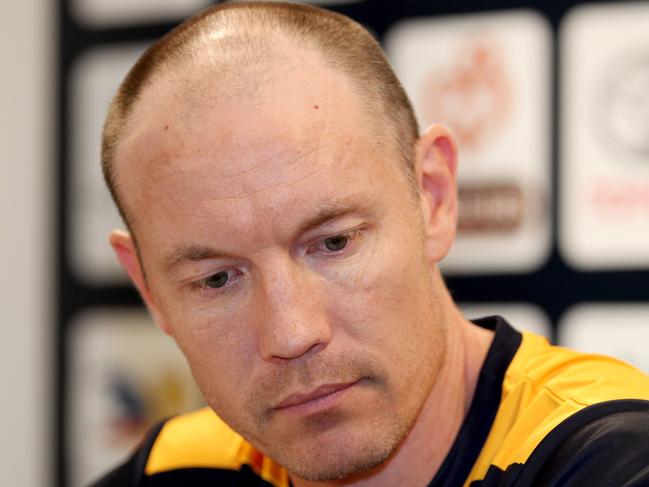 senior Coach Brenton Sanderson listens to a prepared statement from CEO Steven Trigg at a press conference at Adelaide Headquarters on the passing of Dean Bailey from Lung Cancer. PIC SARAH REED.