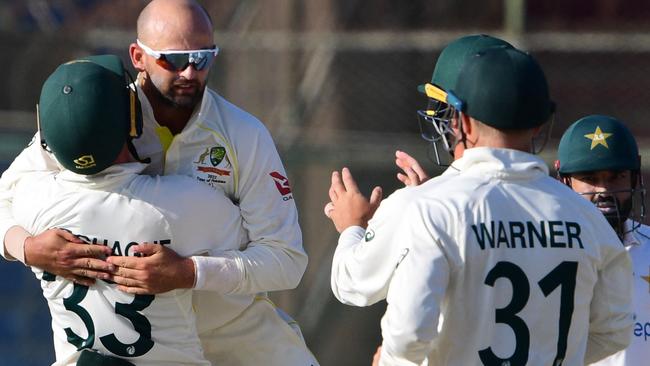 Australia's Nathan Lyon celebrates with teammates the dismissal of Pakistan's captain Babar Azam. Picture: AFP